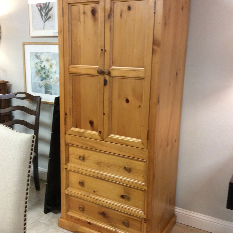 This is a Pine wood, Eddie Bauer Armoire. This armmoire has a cabinet with 2 shelfs and 3 drawers.
