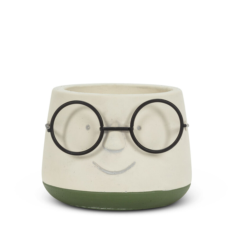 Smarten the look of your favourite plants or flowers with this whimsical Small Face Planter with Glasses.

Crafted out of cement, this ivory and green planter is accented with cheery metal spectacles atop a smiling face that’s sure to bring a smile to yours!

Materials: Cement, Rubber Feet

Width: 2 1/2 inches
Height: 2 1/2 inches
Depth: 2 inches