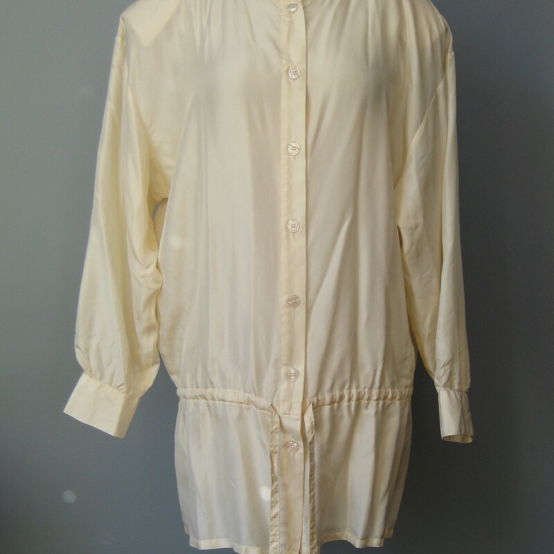 Vtg Quarters Silk, Ivory, Size: Medium<br />
<br />
romantic cottage-y silk blouse from the lates 90s.<br />
It's a bit longer than usual and has a drawstring built into the waist to you can create a pretty blouson effect.<br />
high quality lightweight with front buttons and long button cuff sleeves<br />
<br />
CREAM / IVORY white not bright white.<br />
<br />
Marked Size M, relaxed fit will fit up to a modern size large<br />
flat measurements:<br />
shoulder to shoulder: 22<br />
armpit to armpit: 22<br />
length: 32.25<br />
underarm sleeve seam: 17<br />
waist: 21.5<br />
<br />
thanks for looking!<br />
#43247