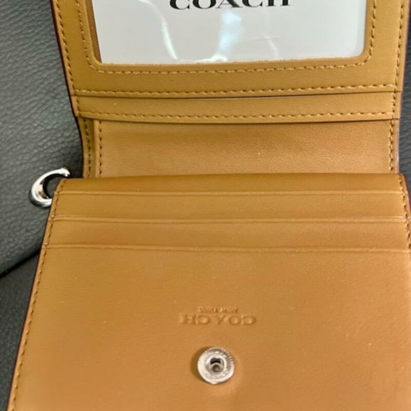 COACH<br />
Snap Wallet With Popsicle Print<br />
Printed coated canvas and smooth leather<br />
Three credit card slots<br />
ID window<br />
Full-length bill compartment<br />
Snap closure<br />
Outside zip coin pocket<br />
4 1/4\" (L) x 3 1/2\" (H) x 1\" (W)<br />
Original Retail Price:  $168.00<br />
This wallet does not appear to ever of been used, original price tag inside.