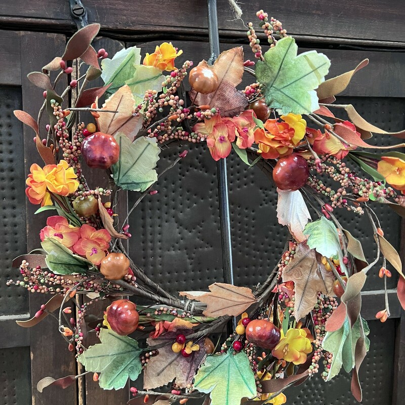 Harvest Garden Wreath is a mix of softly colored assorted fall flowers; leaves; pumpkins; berries;  spirals and pips on a wire wrapped branches. Wreath measures approximately 14 inches outside diameter