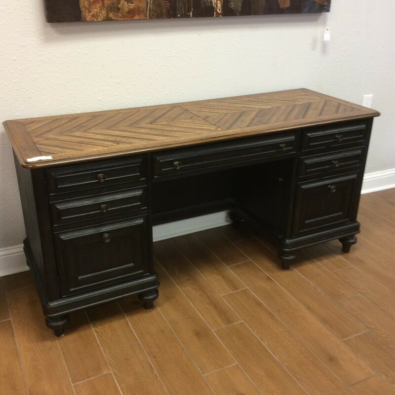 This is a rustic dark brown with wood top, Magnussen Credenza/Desk. This desk has a side cabinet with 2 shelfs, 2 standard drawers, a file drawer and a keyboard drawer. Keys included.