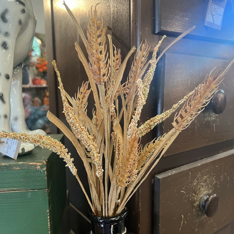 The Wheat and Dried Grass stem is the perfect stem for the fall season. The stem features varied materials and textures, all in a soft golden color to resemble an assortment of dried grasses and wheat.  Display this stem in an arrangement or on its own in a vase, bottle or jar. Stem measures 18 inches in length