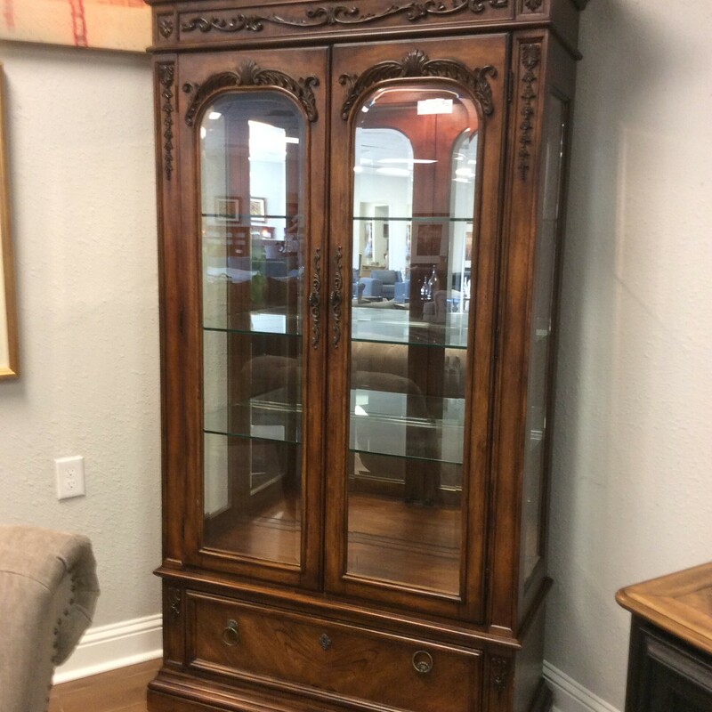 This is a beautiful dark stained wood Broyhill Curio Cabinet. This cabinet has 1 drawer, 3 glass shelfs, and 1 light.