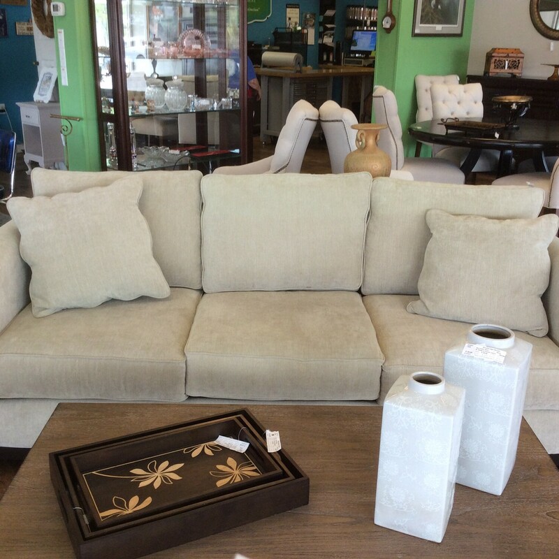 This is a cream Jonathan Lewis sofa that comes with 2 cream pillows.