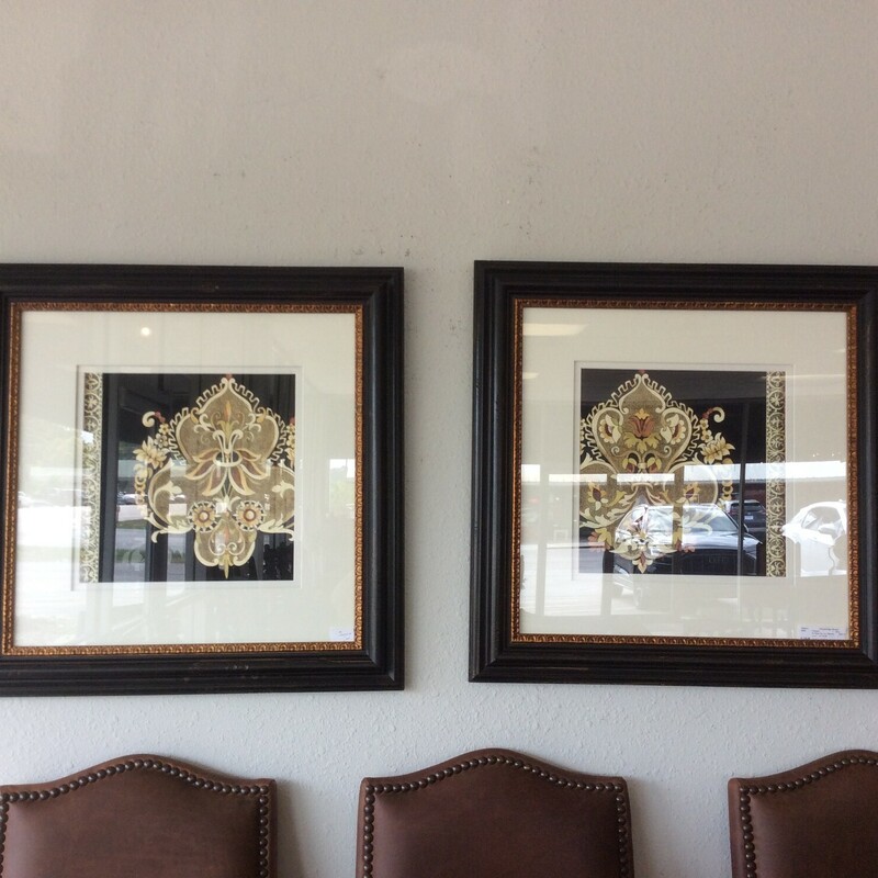 This is a pair of Fleur De Lis pictures, framed in a gold and black frame.