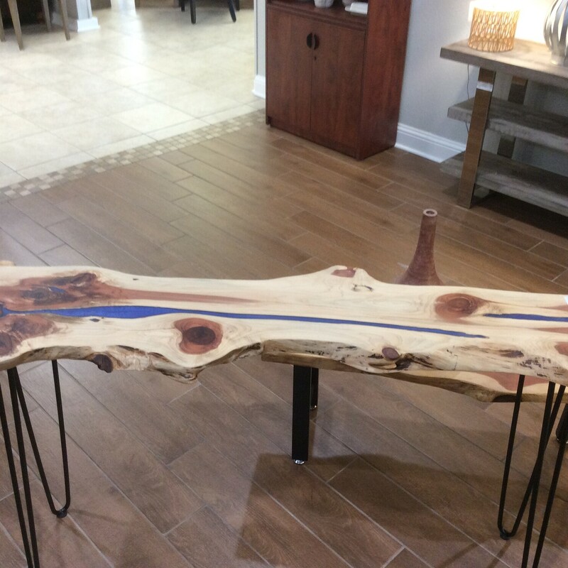 This unique sofa table has a live edge, hairpin legs and a blue epoxy inlaid strip. Great for an entry way or behind a sofa.