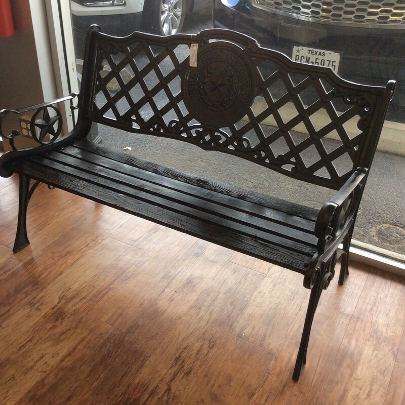 This cast iron park bench has a black painted finish.
