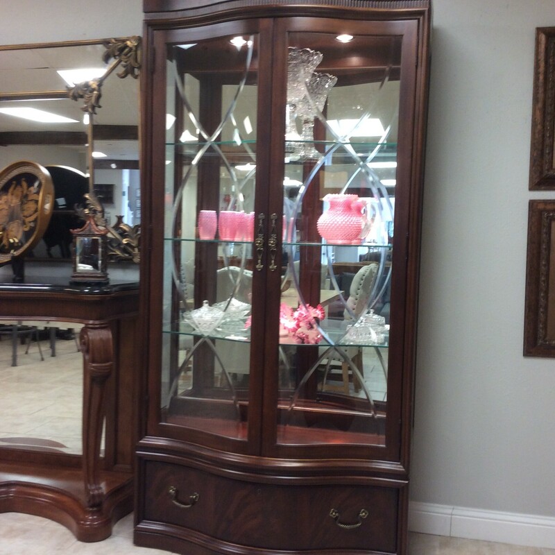 This is a beautiful dark cherry, Thomasville Curio Cabinet. This Curio Cabinet has 3 glass shelfs, mirrored back, etched glass doors and 1 drawer on the bottom with faux key.