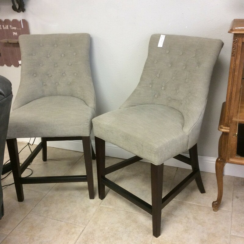 These are a pair of gray/cream, tuffed, upholstered Pottery Barn Bar Stools.