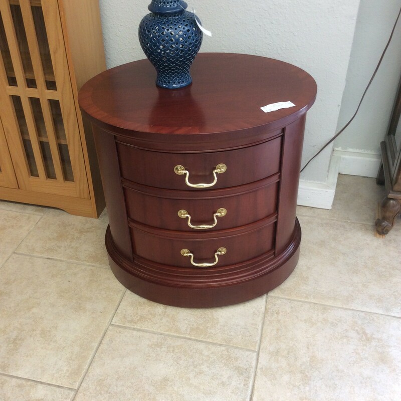 This is a beautiful cherry Bernhardt End round Table. This table has 3 standard size drawers and gold hardware.