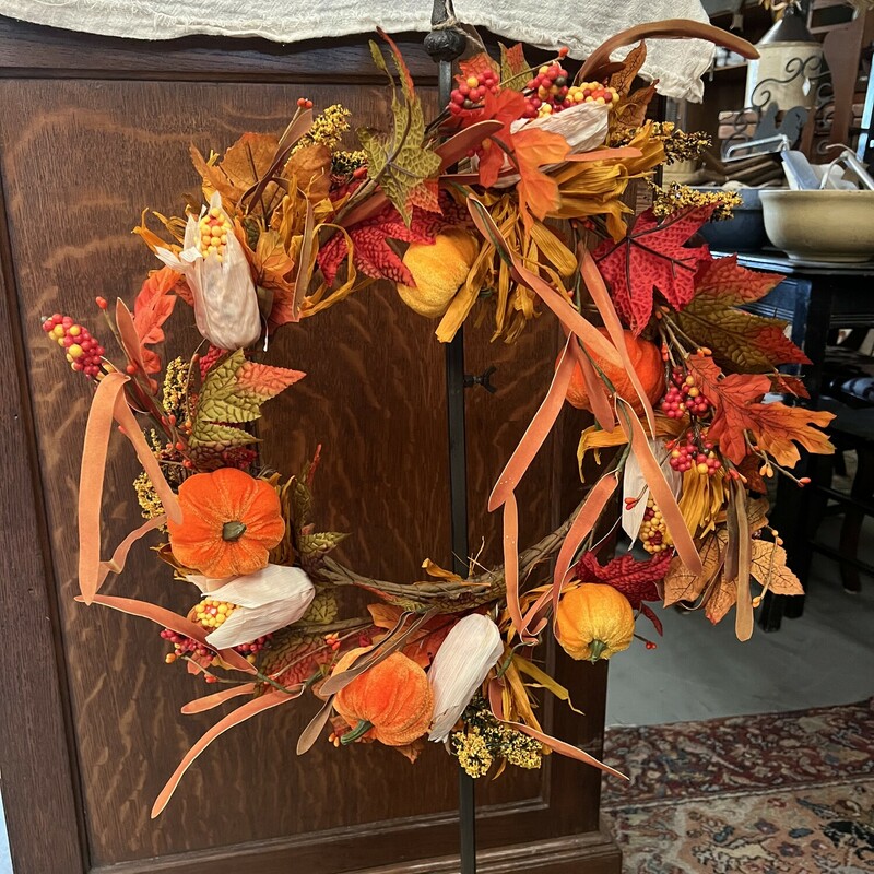 Gorgeous Pumpkin Wreath has velvet orange pumpkins, paper and foam indian corn, fabric leaves and foam leaves and berries. Make a statement this fall season with this wreath.
Measures 10 inches inner and 18 inches outter
