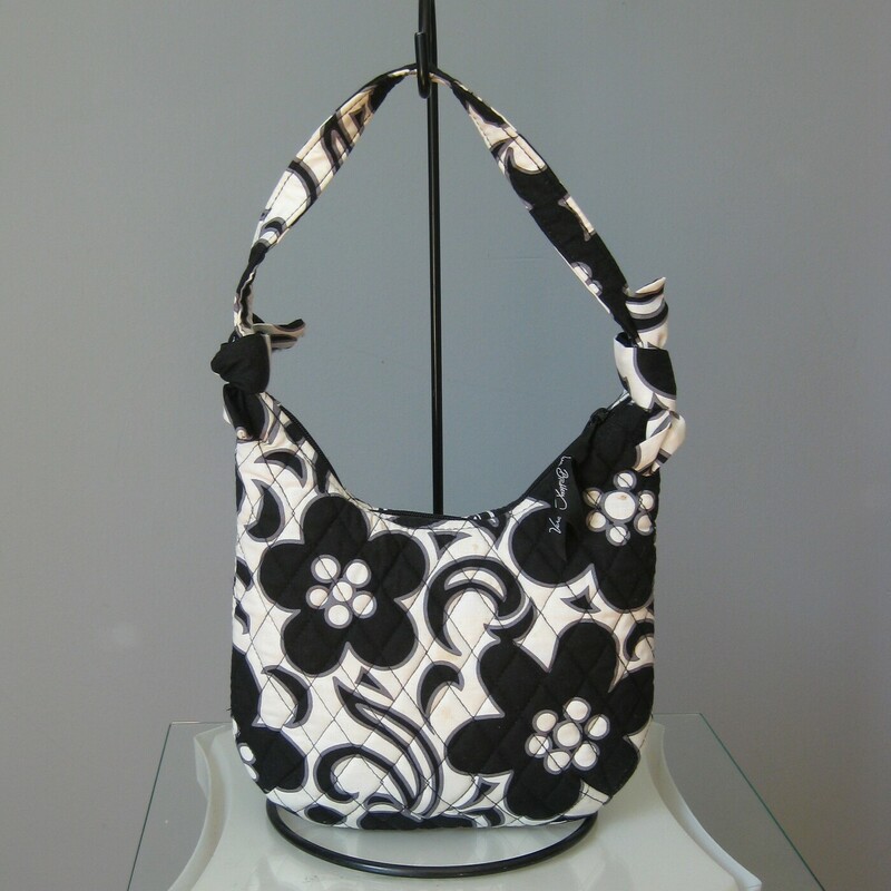 Vera Night & Day Shldr, B/W, Size: Small<br />
Cute mini hobo from Vera Bradley.<br />
The pattern is Night & Day a black and white floral<br />
On the exterior it has three side slip pockets<br />
top zipper closure<br />
The strap is tied on to the side edges so it could be removed if you want to use the bag as a case or clutch<br />
Bag dimenstions: 8.5 x 8 flat when empty but expands to accomodate items, phone should fit.<br />
<br />
Excellent pre-owned condition, no wear but a yellow mark or two as shown.<br />
<br />
thanks for looking!<br />
#49825
