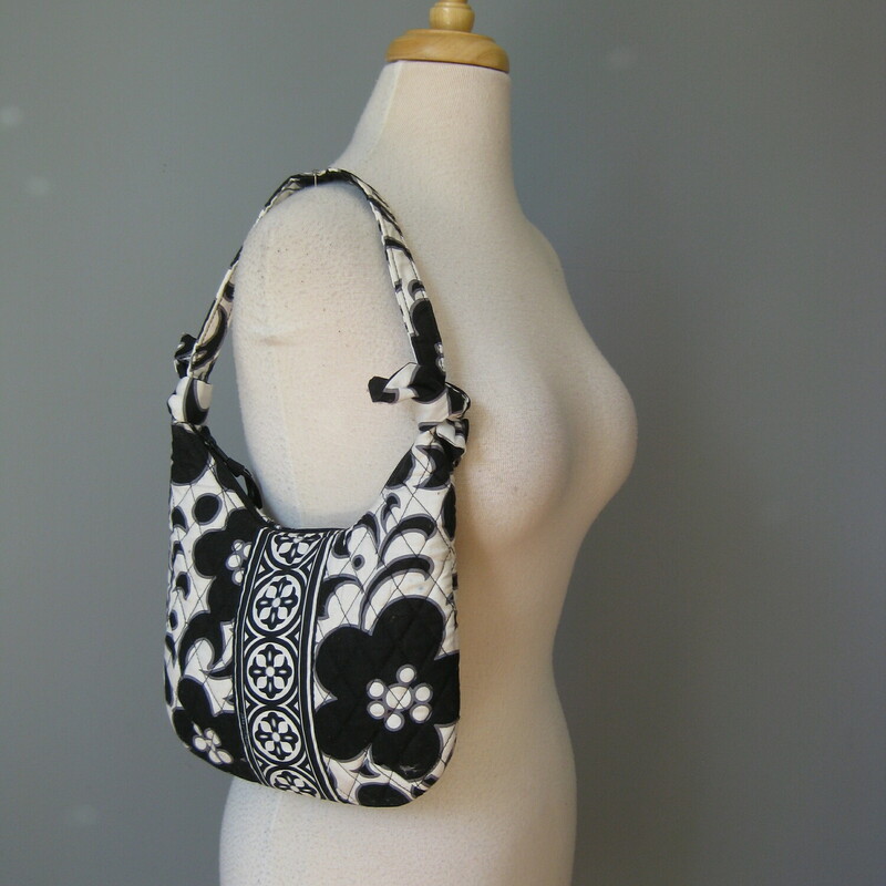 Vera Night & Day Shldr, B/W, Size: Small<br />
Cute mini hobo from Vera Bradley.<br />
The pattern is Night & Day a black and white floral<br />
On the exterior it has three side slip pockets<br />
top zipper closure<br />
The strap is tied on to the side edges so it could be removed if you want to use the bag as a case or clutch<br />
Bag dimenstions: 8.5 x 8 flat when empty but expands to accomodate items, phone should fit.<br />
<br />
Excellent pre-owned condition, no wear but a yellow mark or two as shown.<br />
<br />
thanks for looking!<br />
#49825