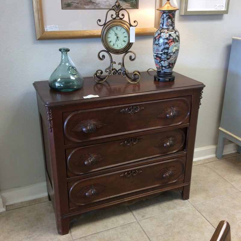 This is a beautiful Antique Dressor. This dresser has 3 drawers and fruit accent handels on the drawers.