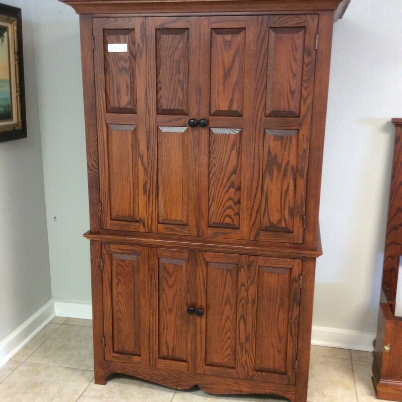 This is a beautiful reddish brown wood armiore. This armiore has 2 cabinets, both with 1 shelf in each cabinet.
