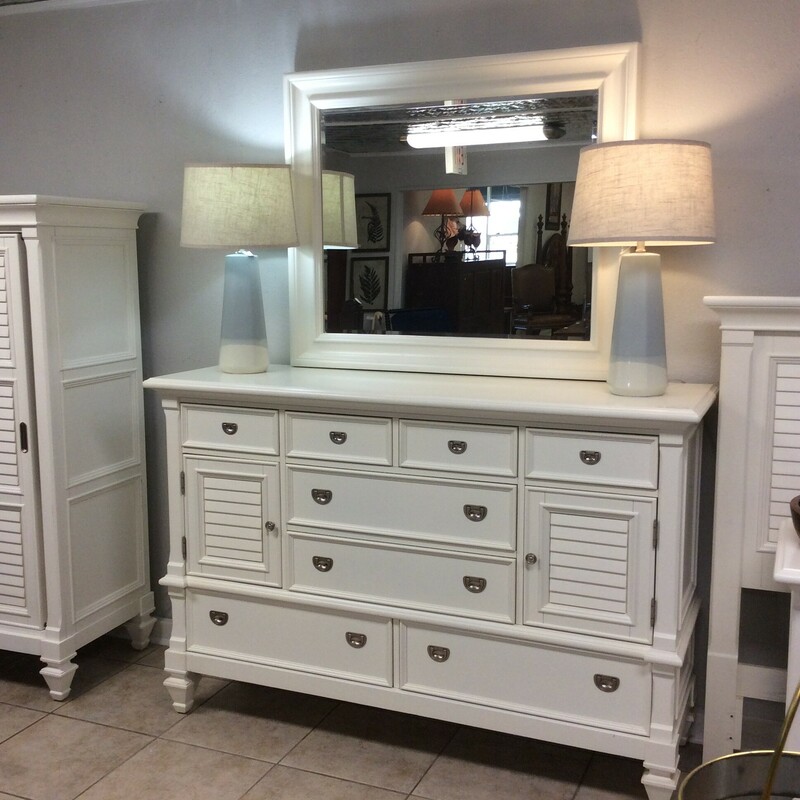 This is a beautiful, white, dresser with mirror. This dresser has 2 cabinets with 1 shelf in each, 4 small drawers on the top and 4 standard size drawers on the bottom.