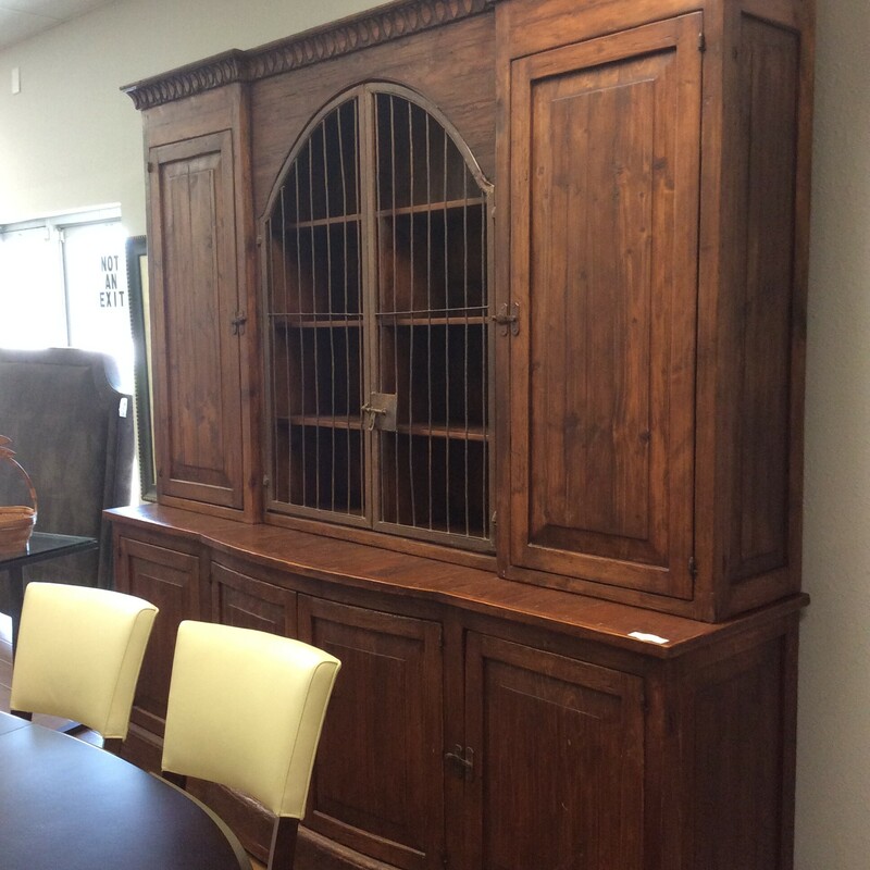 This is a beautiful, large Buffett/Hutch. This hutch has 5 cabinets with shelfs and 1 center cabinet with rod iron doors.