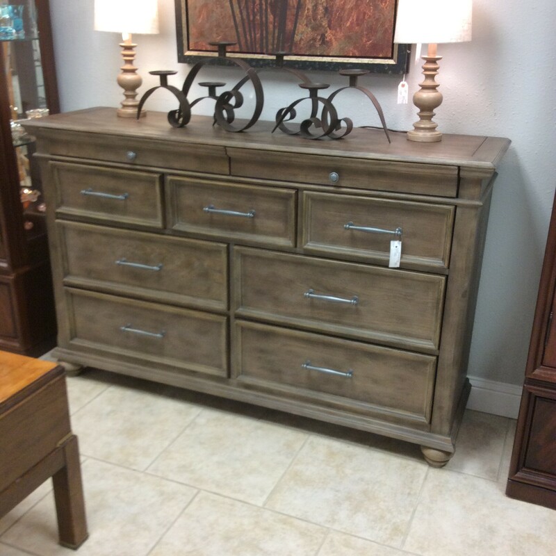 This dresser by Ashley is done in a weathered grey finish with pewter hardware. (matching chest of drawers sold seperately)