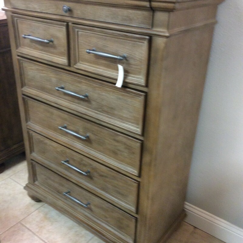 This chest of drawers by Ashley is done in a weathered grey finish with pewter hardware.