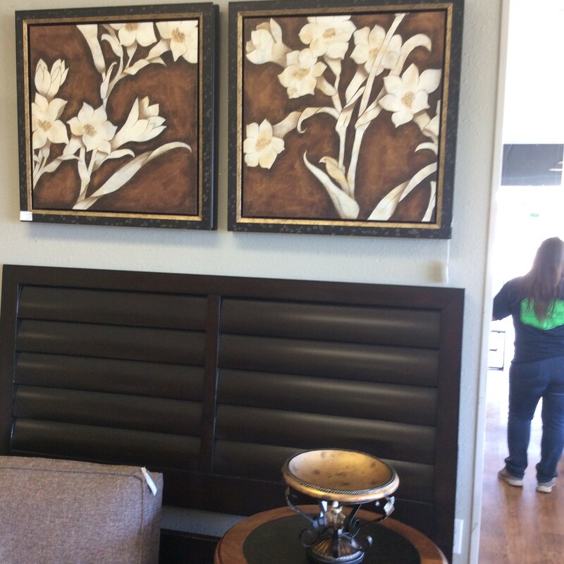 This pair of contemporary paintings feature white flowers against a bronze background.