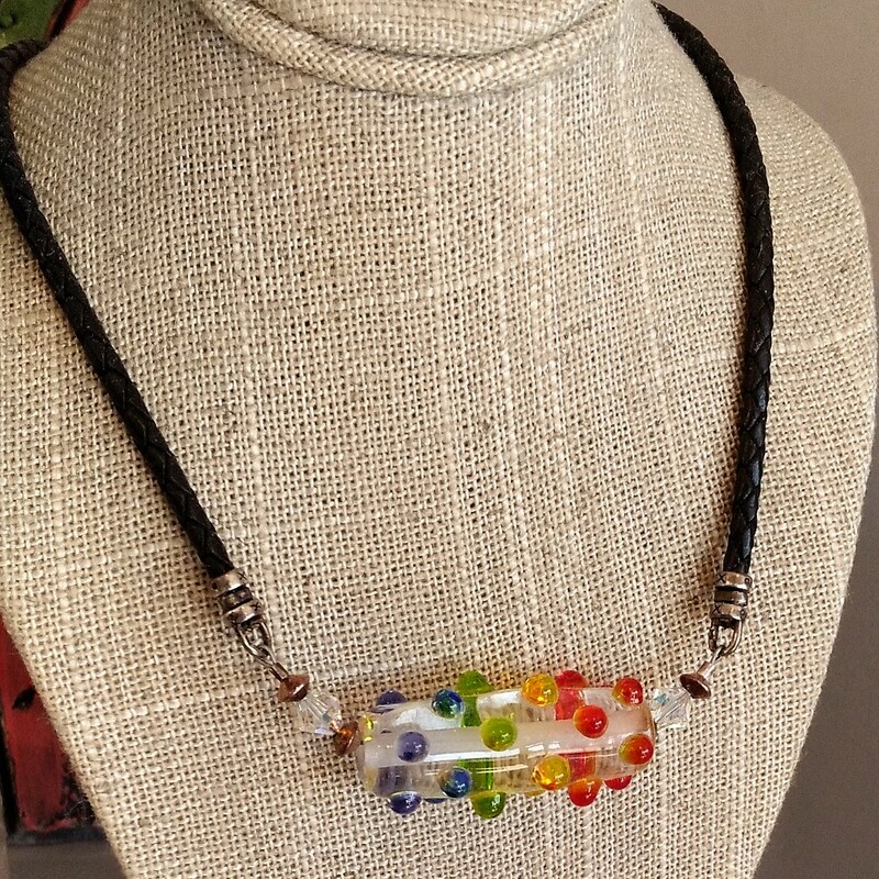 Rainbow Cord

From the Seaside Cliffs collection of Gladmist Glass Design. Hand torched glass beads with Sterling Silver and Swarovski crystals. Necklace is finished with leather and an easy but secure hook and eye closure. Finished length is 23 inches.