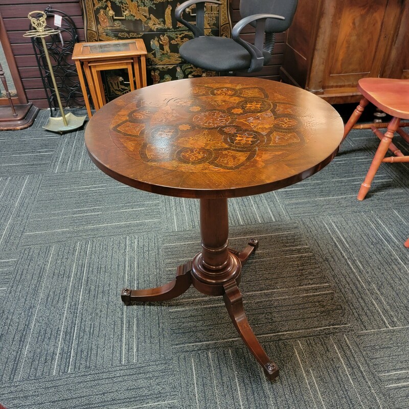 Small Antique Stand with Fabulous Inlaid Top.  Has some finish wear due to age.  Measures 24' round top; 29' tall.