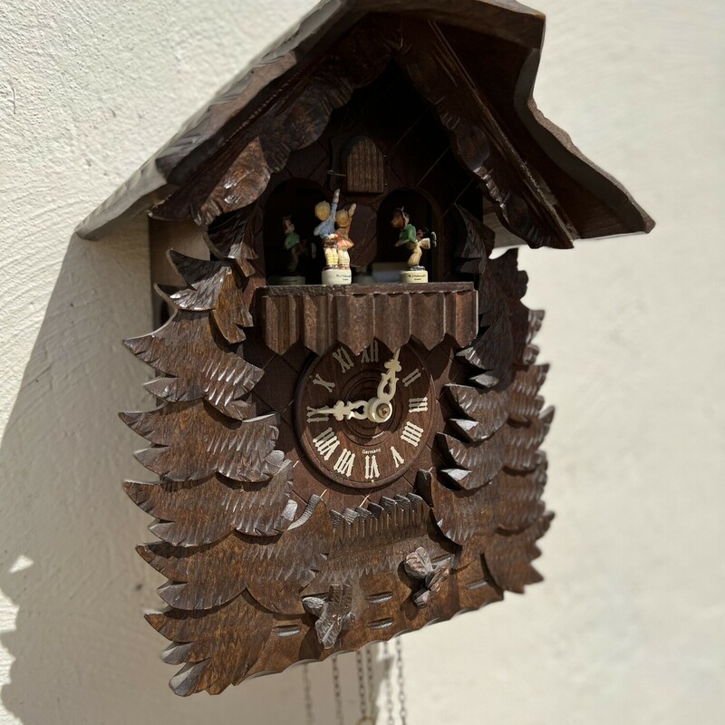 Vintage Hummel Bavarian cuckoo  clock.

A very unique find!

Beautifully carved wooden Bavarian cuckoo clock with authentic M.J. Hummel figurines.

Has cast iron pine cone hangings.

Comes with original paperwork and information pamphlet.

This clock has not been tested; unsure if it works.

There is minor wear on the clock and a small chip in the wood.

Clock: 12 1/2in tall x 9in wide x 4 1/2in deep
Total height: approx. 45in tall