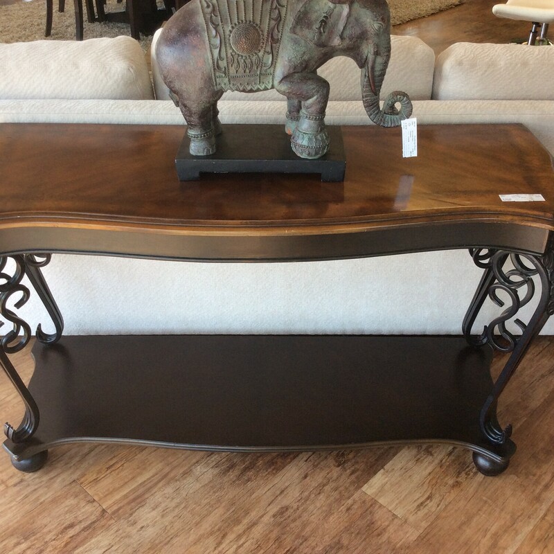 This is a beautiful brown and metal sofa table.