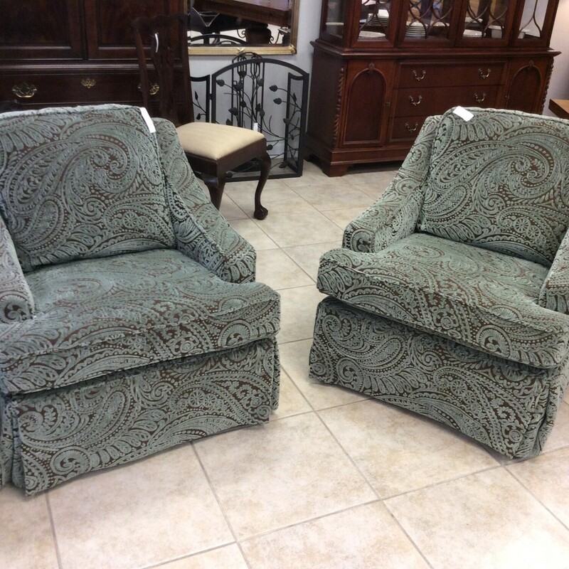 This is a pair of beautiful aqua and brown paisly swivel chairs.