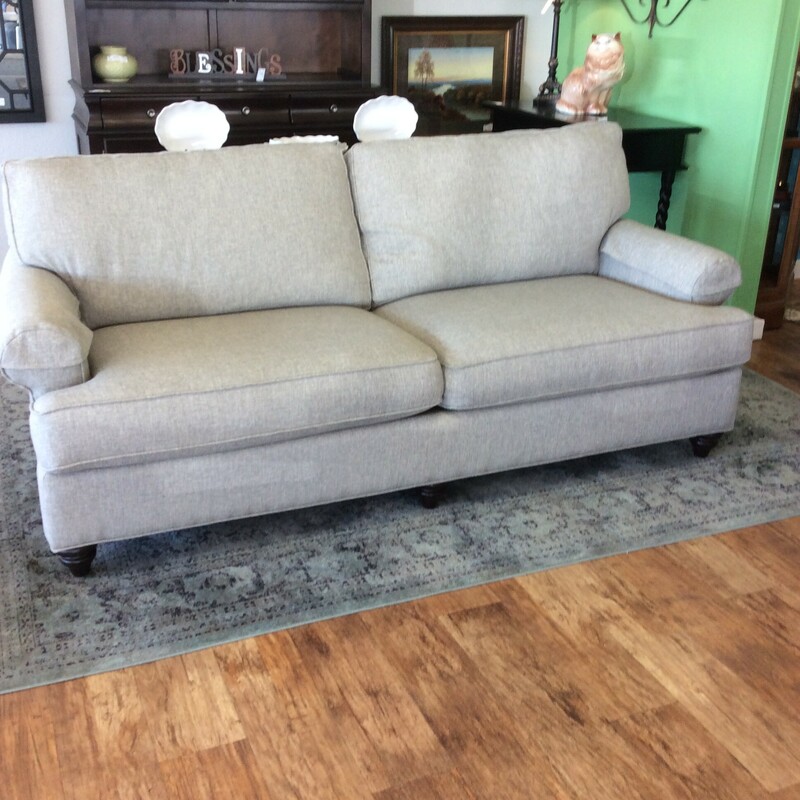 This custom sofa by Bassett is upholstered in an Oatmeal tweed fabric.
