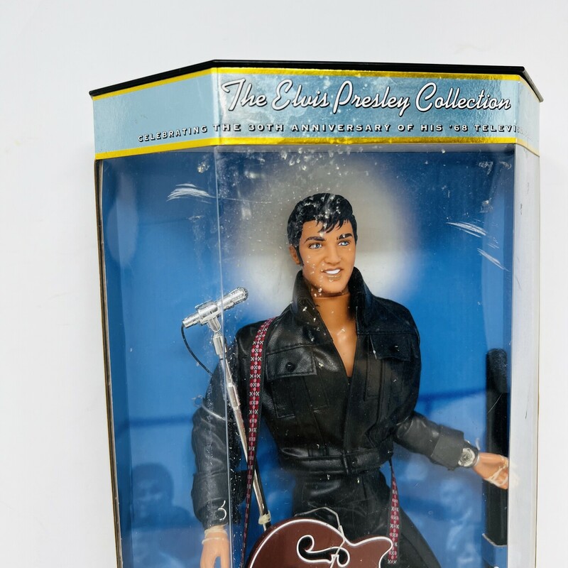 Vintage Elvis Presley 30th anniversary doll.<br />
<br />
A true vintage!<br />
<br />
Celebrating the 30th anniversary of his 1968 television special!<br />
<br />
Elvis is wearing a black leather motorcycle jacket, black leather pants, black biker boots, a silver watch, and a red Gibson electric guitar.<br />
<br />
Comes with a shiny silver microphone and stand.<br />
<br />
From the Elvis Presley Collection, first in the series.<br />
<br />
Comes in the original box.<br />
<br />
There is minor wear and tear on the box.<br />
<br />
8in wide x 13 1/2in tall