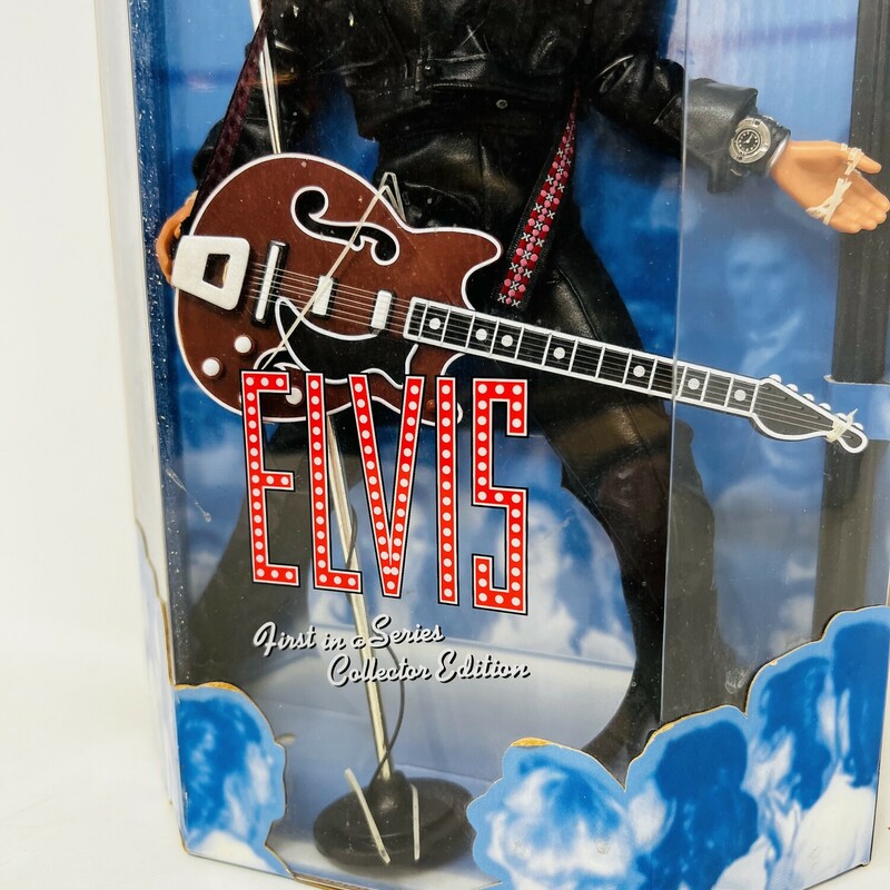 Vintage Elvis Presley 30th anniversary doll.

A true vintage!

Celebrating the 30th anniversary of his 1968 television special!

Elvis is wearing a black leather motorcycle jacket, black leather pants, black biker boots, a silver watch, and a red Gibson electric guitar.

Comes with a shiny silver microphone and stand.

From the Elvis Presley Collection, first in the series.

Comes in the original box.

There is minor wear and tear on the box.

8in wide x 13 1/2in tall