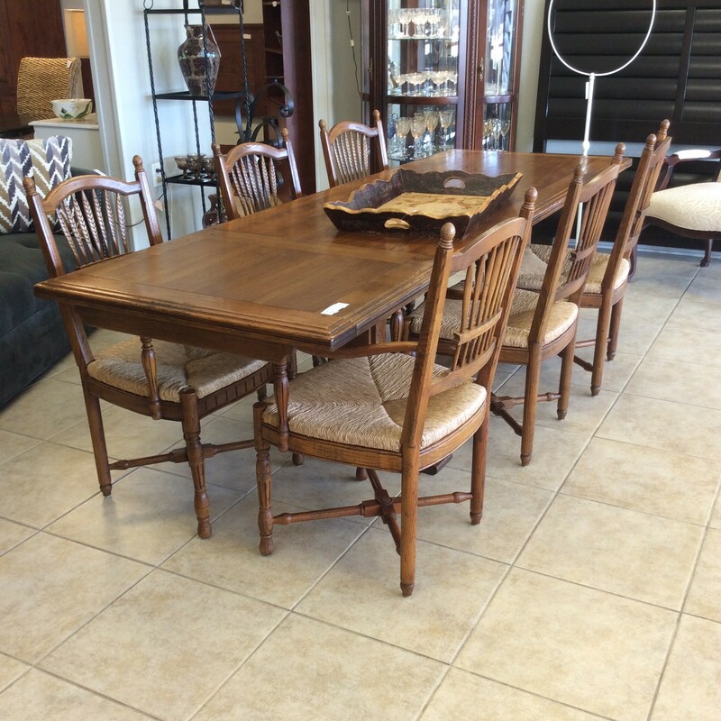 This charming oak Tressel Table has six chairs with rush seats and a carved wheat design on the chair backs.