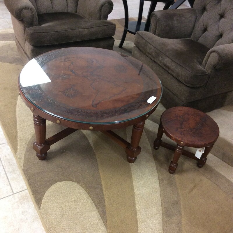This is a South America Map Coffee Table. This coffee table has a leather and a glass protective top.