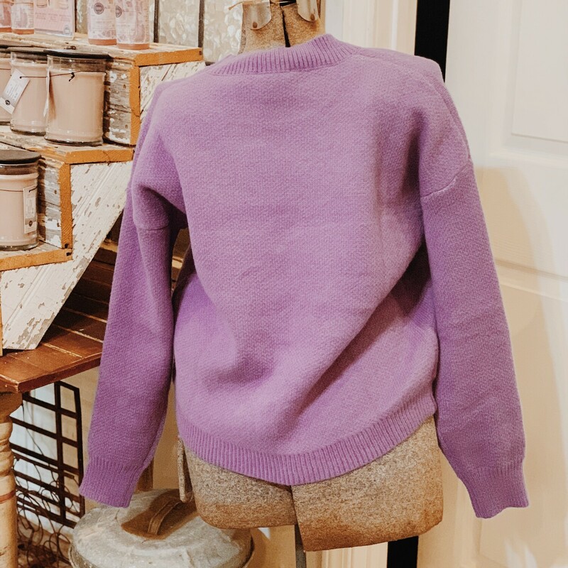 These adorable, purple sweaters are perfect for fall and winter! They are a thicker material and have a smiley face on the front!