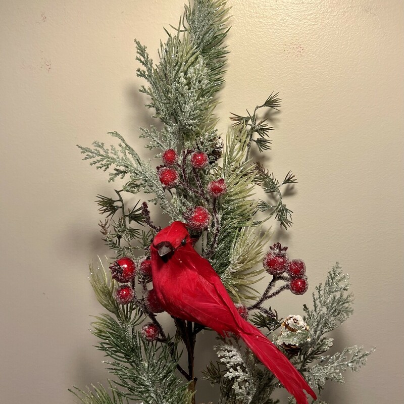 This beautiful stem is a perfect ready-to-display floral. It features a variety of pine greenery accented with snowy pinecones and icy red berries. It is coated in a dusting of glitter and complemented by a bright feather cardinal perched in the center. It makes a pretty centerpiece in any vase or container or can easily be added to a wall basket. Stem measures 26 inches high