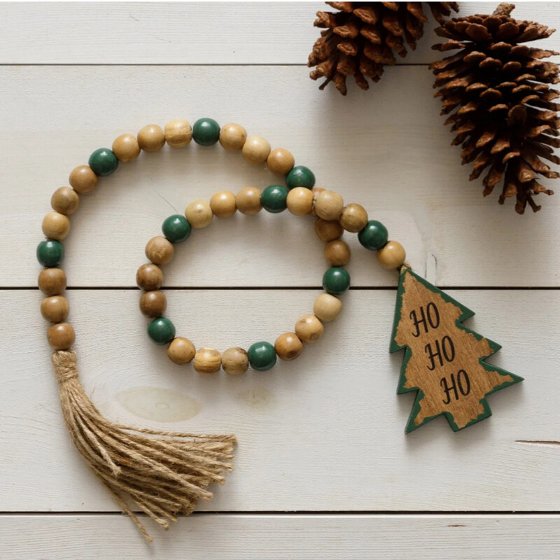 This beautiful strand of Christmas Tree Beads is made of wood and is a perfect addition to any holiday decor. Drape it on your tree; candle holders or rings;  a stack of books; or around florals in a dough bowl.   The wood tree is double sided and measures 4 inches in length; total strand measures 37 inches