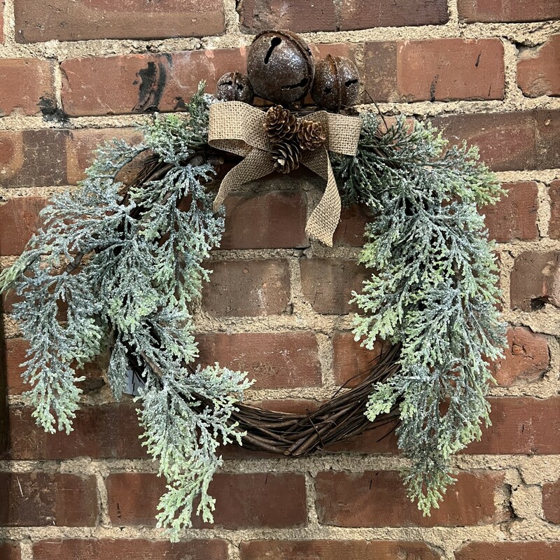 Add warmth and elegance to your home with this Counrty Cedar Bell Wreath.  Artificial cedar on a natural grapevine base and has been coated in glistening glitter, accented with jingle bells, pinecones, and a burlap bow. This wreath adds an invinting wintertime display on your front door or anywhere in your home. Measures 17 inches in diameter