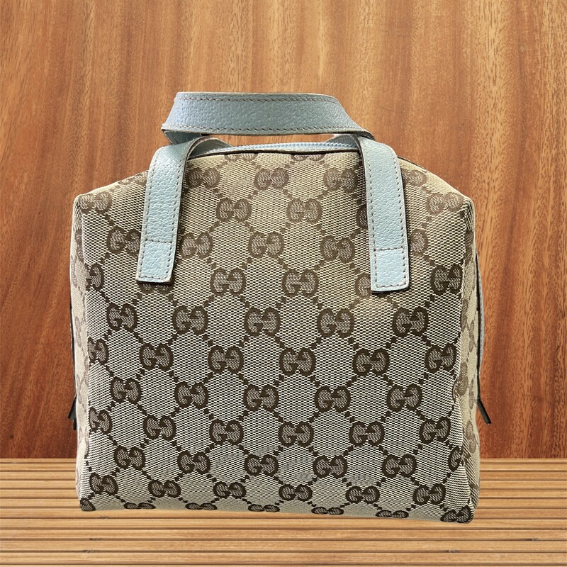 GUCCI GG Canvas MINI Zip around Bowling BAG
This bag is VINTAGE
Serial Number 124542-0416
Size:
Length: 7.50 in
Width: 4.00 in
Height: 7.50 in
Drop: 2.75 in
This is an authentic GUCCI Monogram Mini bag in Sky Blue. This stylish mini satchel is crafted of beige Gucci GG monogram canvas. The bag features sky blue leather top handles and trim with a wrap around zipper. This opens to a black fabric interior. This is a superb tiny tote for everyday essentials from Gucci!
Great Buy for someone starting to branch out to GUCCI or add a fun Vintage piece to their collection.
Overall in good condition.  Signs of wear on the handles.  Canvas and Interior in great condition.
Most sites are selling this bag easlily over $500.00
Adorable!