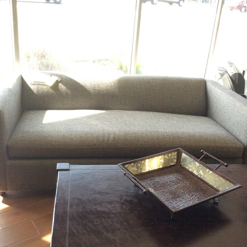 This movie sleeper by Crate and Barrel is upholistered in a grey tweed fabric with a single bottom cushion.