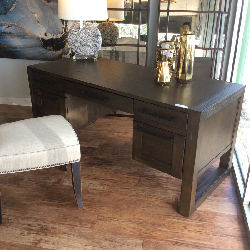 This contemporary style desk has clean lines and a dark wood finish.