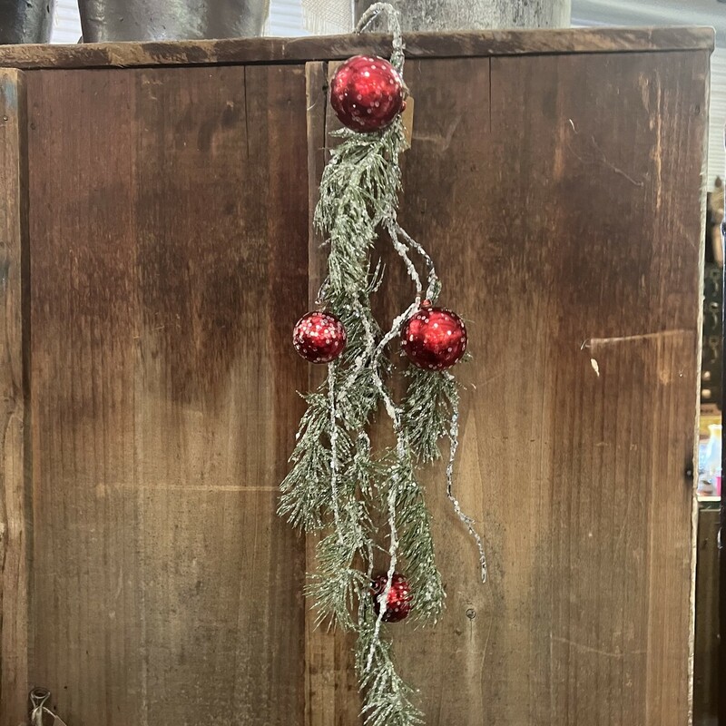 Red bulb and pine spray is a winter floral with plastic pine needles and red bulbs on a long slender, brown paper wrapped stem and is lightly snowed and glittered .Spray can be adjusted for a fuller look and it is perfect for display in a can, pitcher vase or wall pocket. Measures 42 inches long