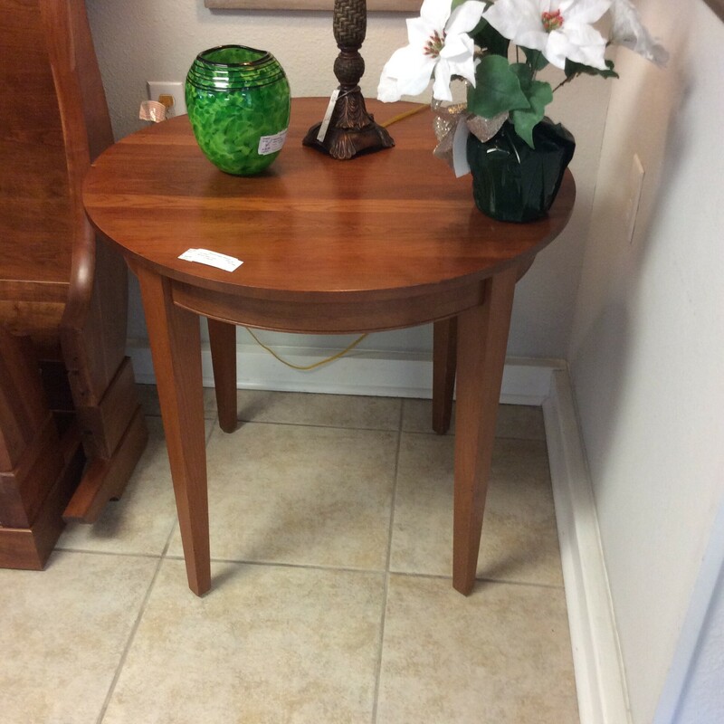 This is a cherry, round, side table.