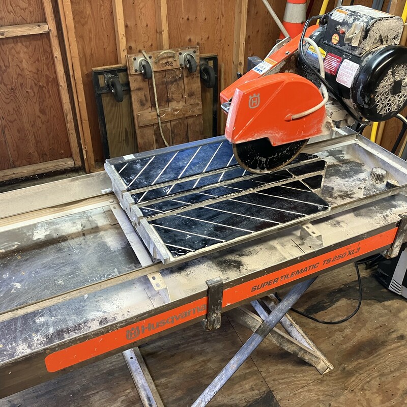 Wet Tile Saw, Husqvarna,  TS 250 XL3<br />
Stainless Steel Pan<br />
<br />
<br />
<br />
Built for the professional who performs high production sawing, the Husqvarna Super Tilematic TS 250 X3 is designed to cut big tiles and to deliver the required cutting power. The sliding water pan allows instant adjustment form small to large material for unequaled productivity and convenience.<br />
<br />
<br />
Features<br />
<br />
<br />
<br />
Patented sliding tray design allows maximum cutting capacity on large tiles.<br />
The adjustable rolling stand has a patent-pending spring-assist for easy raising/lowering of saw.<br />
The cutting head can be adjusted to various heights<br />
Smooth rolling, large conveyor carts with metal wheels maintain high precision with fewer parts and less wear<br />
10\" blade capacity for cutting thicker material.<br />
Choose rust-resistant galvanized pan or rust-proof stainless steel for easiest cleaning and maintenance.<br />
Ability to make spring-assisted plunge cuts.<br />
Bladeshaft lock makes blade removal easier.<br />
Features a 1-1/2 hp Baldor single or dual voltage continuous-duty motor that is a totally enclosed fan cooled (T.E.F.C.) and designed exclusively for Husqvarna.<br />
Single voltage models feature dual capacitors for increased power efficiency in low voltage starting conditions.<br />
Motors are UL and CSA approved.<br />
Single voltage models have six groove poly V-belts while dual voltage models have premium dual 3VX belts that drive the blade at the proper speed for optimum blade performance.