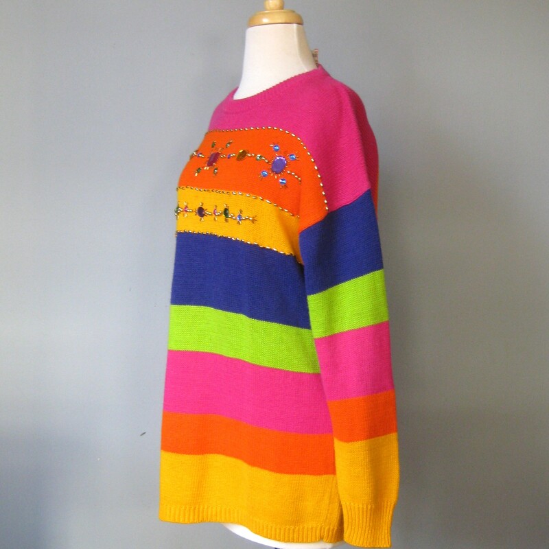 Vtg Santoria Striped Jewd, Org/Pink, Size: Medium<br />
<br />
Long slouchy sweater with stripes and jewels in vivid colors.<br />
purple, yellow, green, orange,<br />
Large and small plastic jewels and gold beads are embroidered across the chest.<br />
By Santoria<br />
Cotton ramie blend.<br />
Marked size M but will fit larger<br />
flat measurements:<br />
shoulder to shoulder: 23<br />
armpit to armpit: 21<br />
length: 27<br />
underarm sleeve seam: 19.75<br />
width at hem unstretched: 20<br />
Excellent condition, no flaws!<br />
<br />
thanks for looking!<br />
#54759