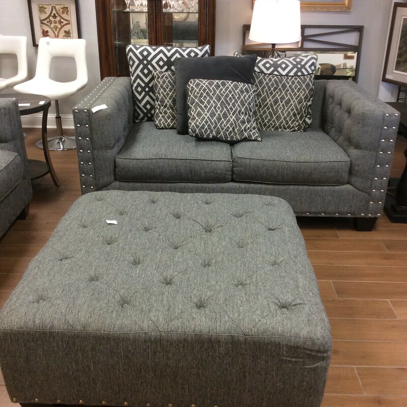 This is a gray linen, Cindy Crawford Loveseat with nailhead trim. This loveseat comes with a gray linen, tuffed ottoman with nailhead trim and decor pillows.