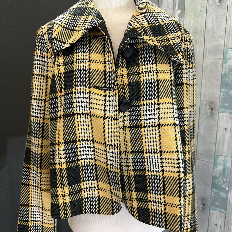 Add this flirty plaid jacket to your wardrobe and you will be stopping traffic. Two button closure.
