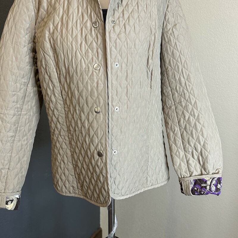 Lightweight quilted jacket with purple paisley lining. Snap closure.