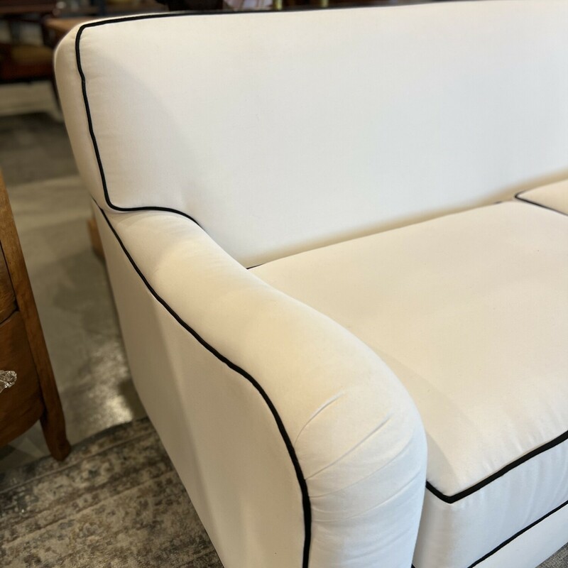 Fabulous modern white couch.

Sleek and modern white fabric couch with black trim detailing.

There are minor stains on the couch.

73in long x 33in tall x 33in deep